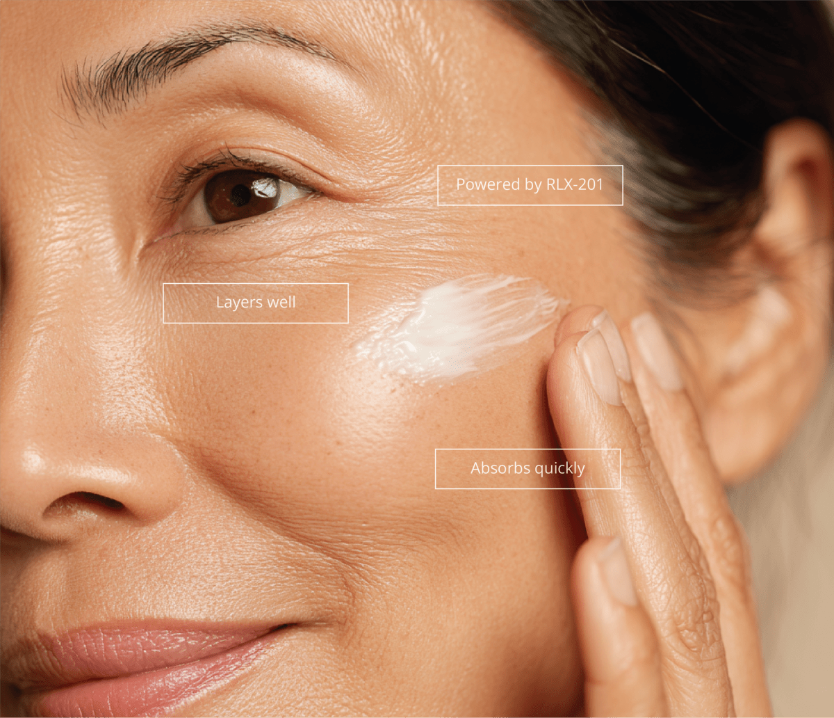 Woman applying Re-Q longevity face serum to her cheek, labeled powered by RLX-201, layers well, absorbs quickly